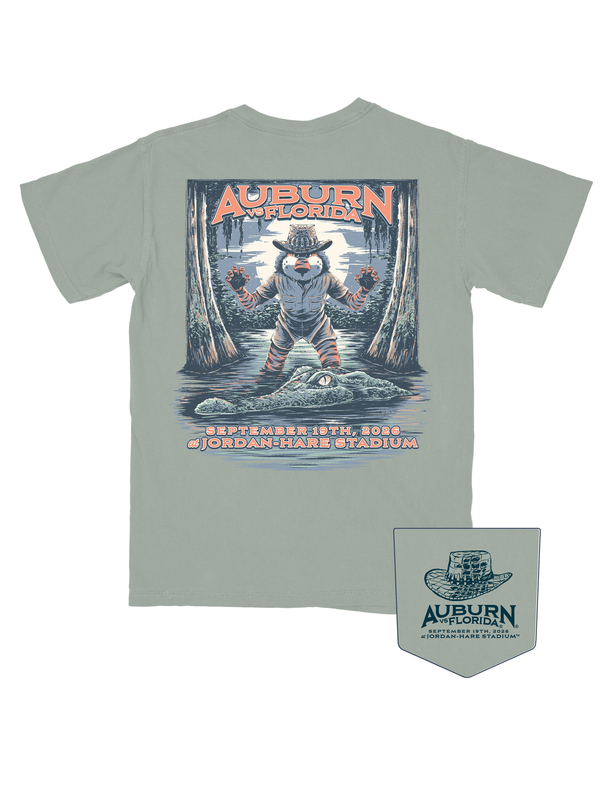 Auburn University Bay Shirt with an image of Aubie standing in a moonlit swamp, wearing an alligator skin hat and a khaki shirt and shorts, ready to pounce on a passing Gator