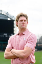 University of Alabama Men's Crimson Stripe Performance Polo with an embroidered image of Big Al in a baseball uniform leaning on a baseball bat