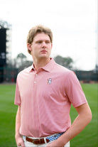 University of Alabama Men's Crimson Stripe Performance Polo with an embroidered image of Big Al in a baseball uniform leaning on a baseball bat