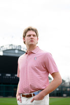 University of Alabama Men's Crimson Stripe Performance Polo with an embroidered image of Big Al in a baseball uniform leaning on a baseball bat