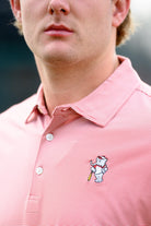 University of Alabama Men's Crimson Stripe Performance Polo with an embroidered image of Big Al in a baseball uniform leaning on a baseball bat