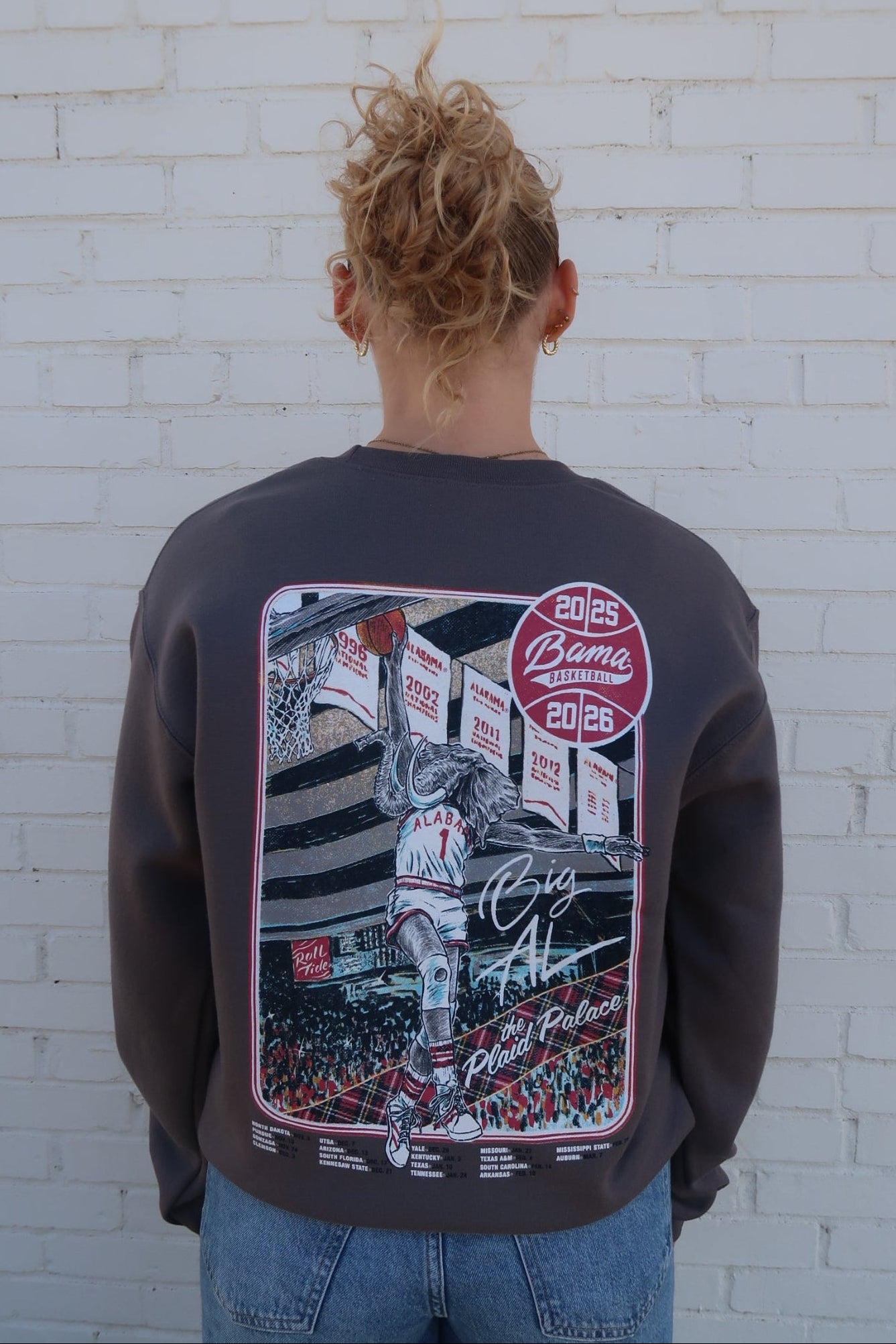 University of Alabama Dark Grey Sweatshirt with an illustration of Big Al dunking a basketball next to text “Big Al” and “the Plaid Palace” above the 2025 Basketball Schedule