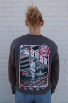University of Alabama Dark Grey Sweatshirt with an illustration of Big Al dunking a basketball next to text “Big Al” and “the Plaid Palace” above the 2025 Basketball Schedule