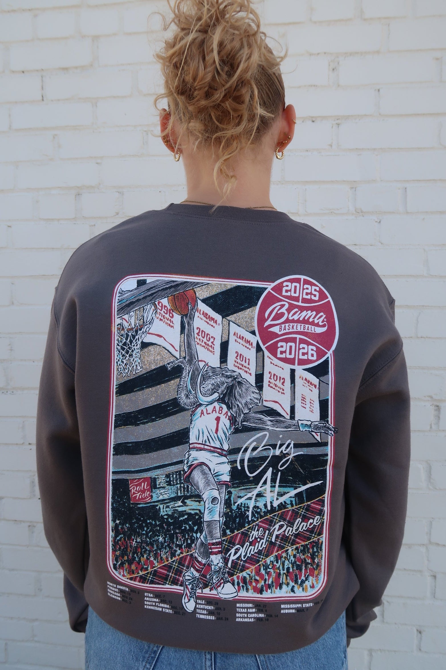 University of Alabama Dark Grey Sweatshirt with an illustration of Big Al dunking a basketball next to text “Big Al” and “the Plaid Palace” above the 2025 Basketball Schedule
