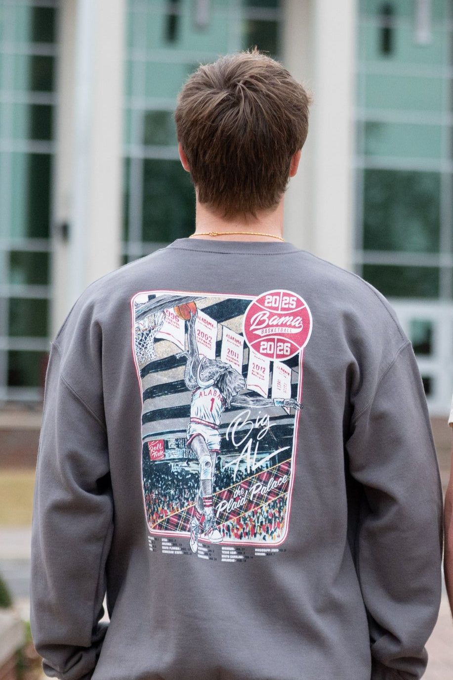University of Alabama Dark Grey Sweatshirt with an illustration of Big Al dunking a basketball next to text “Big Al” and “the Plaid Palace” above the 2025 Basketball Schedule