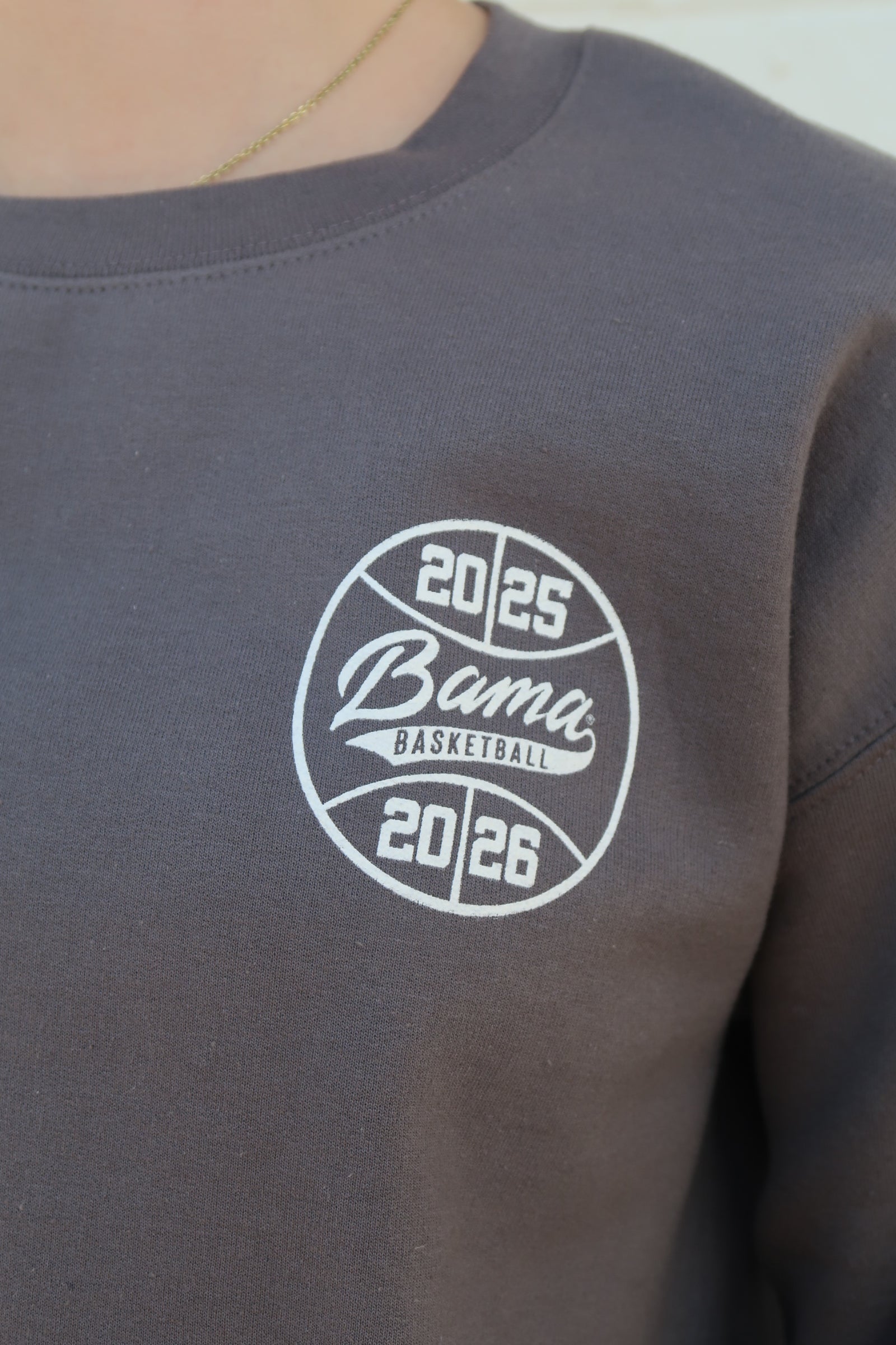 University of Alabama Dark Grey Sweatshirt with an illustration of Big Al dunking a basketball next to text “Big Al” and “the Plaid Palace” above the 2025 Basketball Schedule