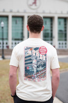 University of Alabama Ivory Shirt with an illustration of Big Al dunking a basketball next to text “Big Al” and “the Plaid Palace” above the 2025 Basketball Schedule