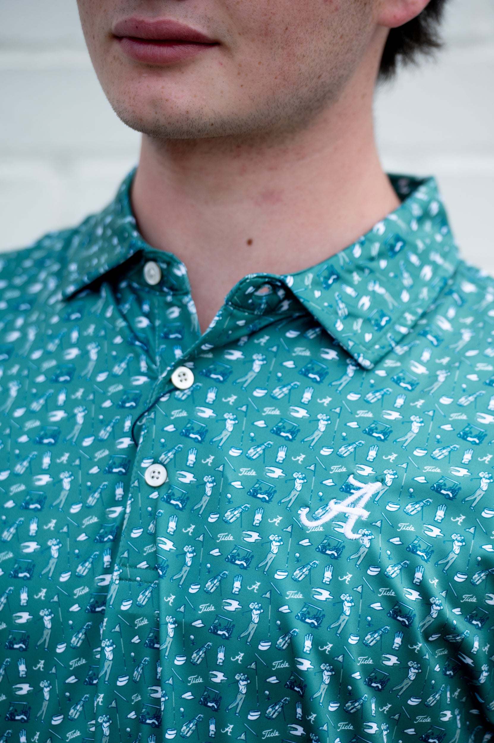 University of Alabama Green Men’s Polo with an Alabama golf-themed pattern and Silver Script A Logo embroidery