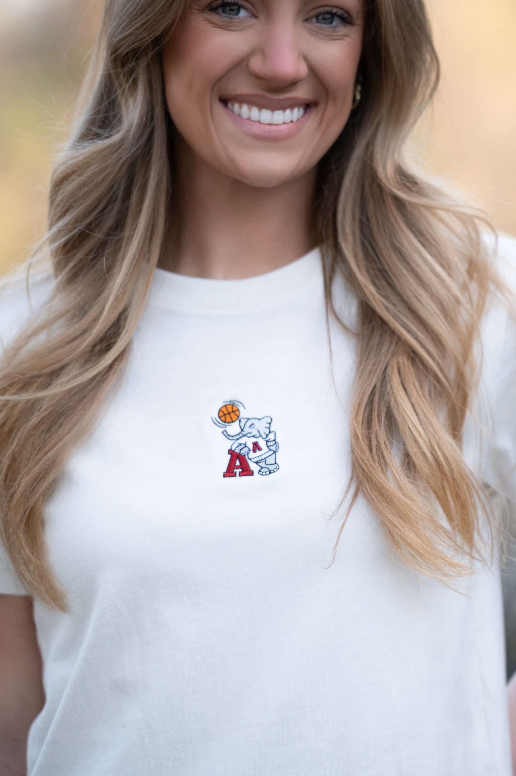 University of Alabama Off-White Ladies Short Sleeve T-Shirt with the Basketball Al Logo embroidered on the middle of the chest