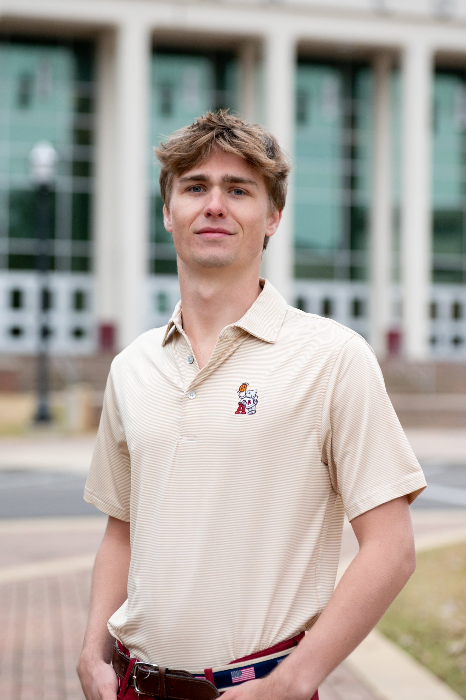 University of Alabama Basketball Al Tan Men’s Polo with an embroidered Big Al in a sweater holding a basketball and leaning against an "A"
