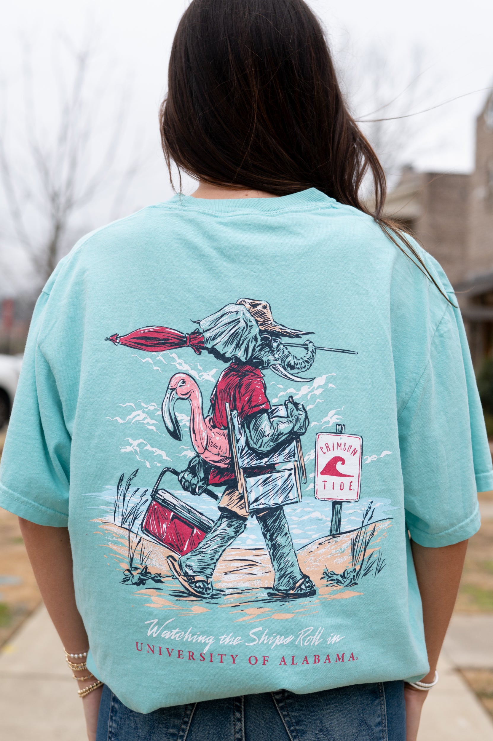 University of Alabama Big Al Beach Chalky Mint Comfort Colors T-Shirt with an image of Big Al in beach clothes carrying an umbrella dragging a cooler across the sand