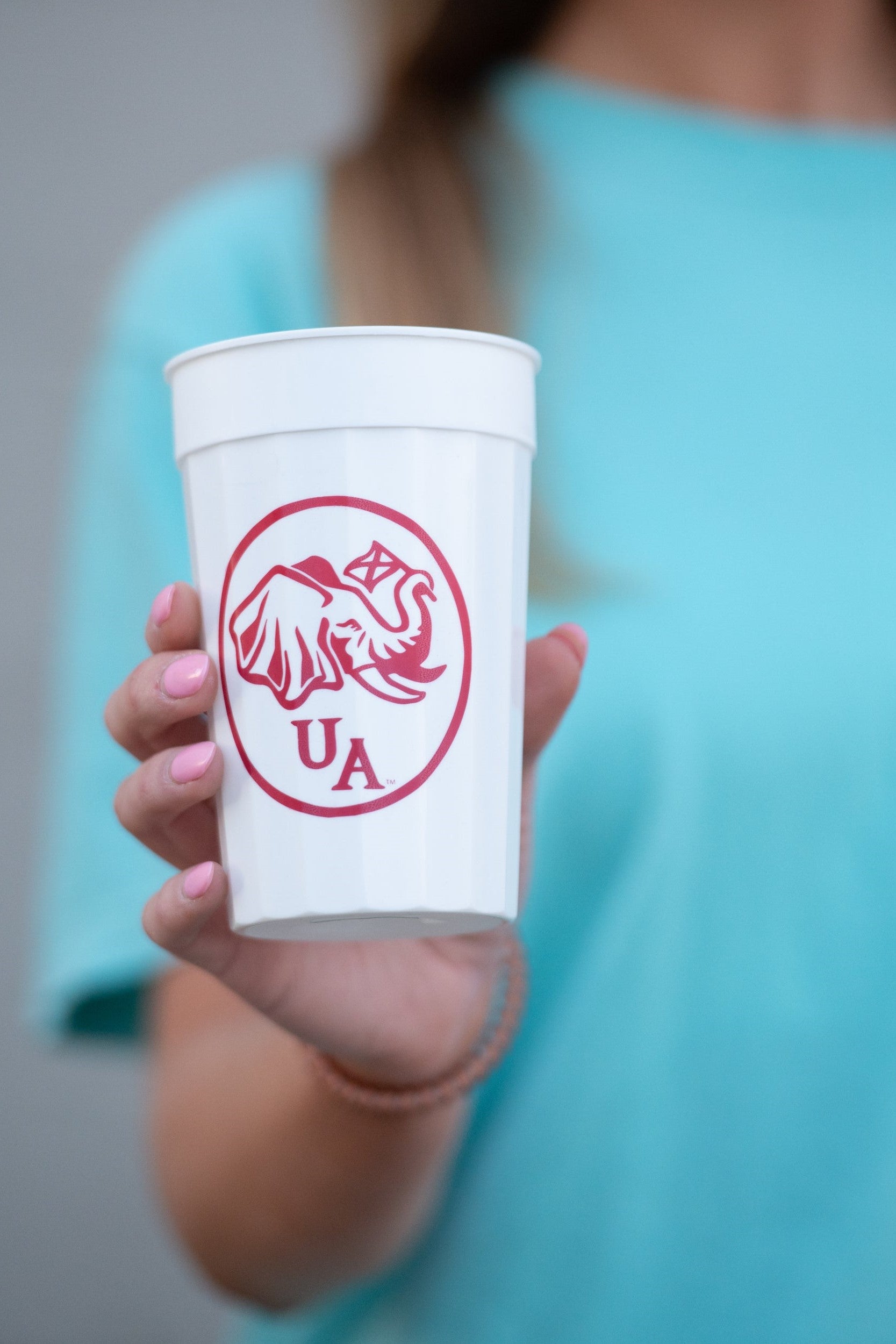 University of Alabama White Stadium Cup with an image of an elephant holding an Alabama State flag above the letters "UA"