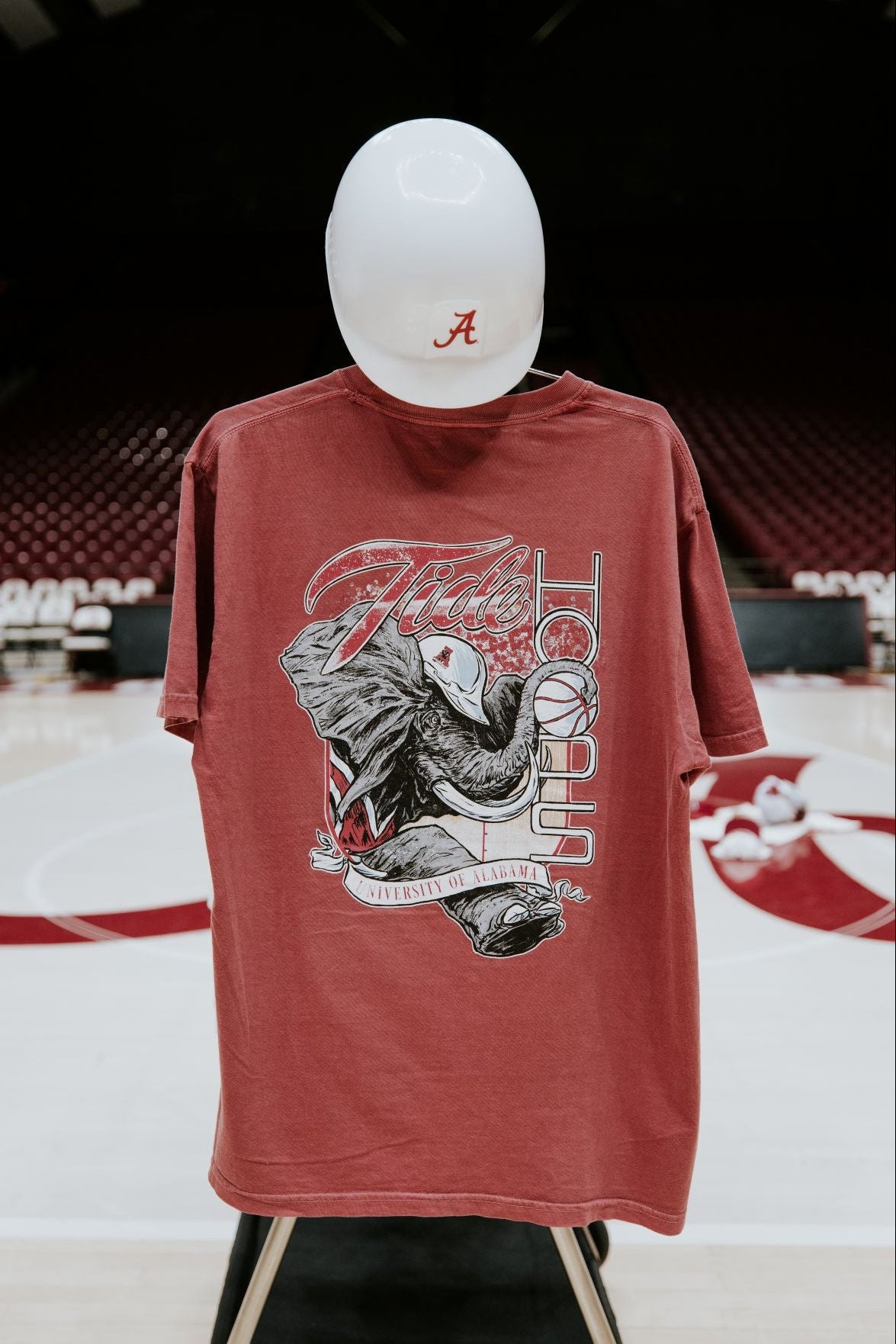 University of Alabama Red T-Shirt with Big Al wearing a hard hat and holding a basketball with his trunk to help spell the word “Hoops”