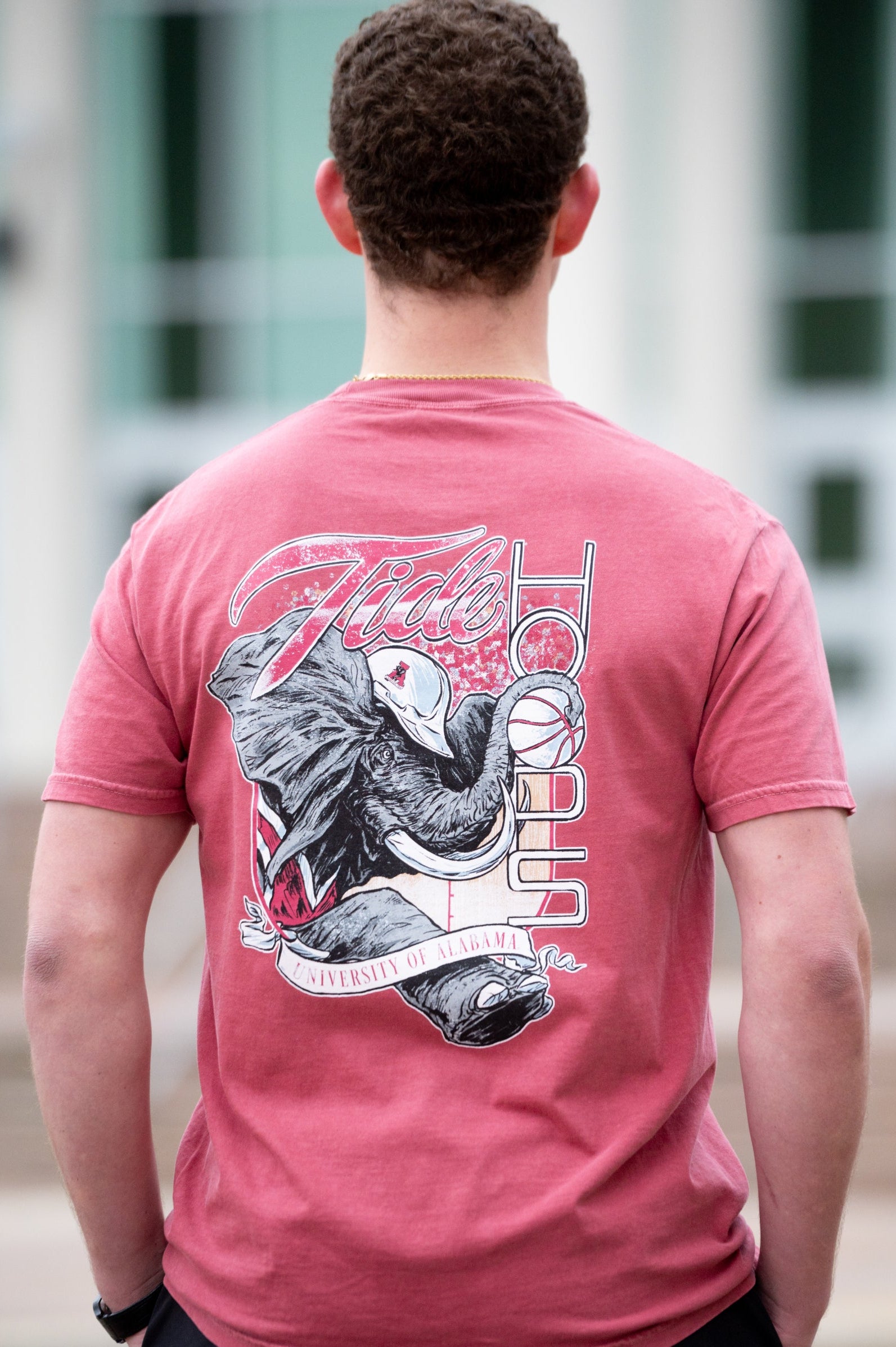 University of Alabama Red T-Shirt with Big Al wearing a hard hat and holding a basketball with his trunk to help spell the word “Hoops”