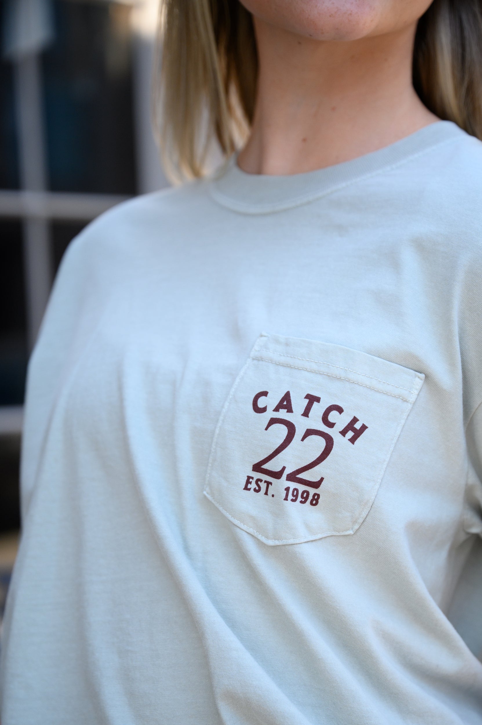 Front pocket design with Brown text “Catch 22- EST. 1998”
