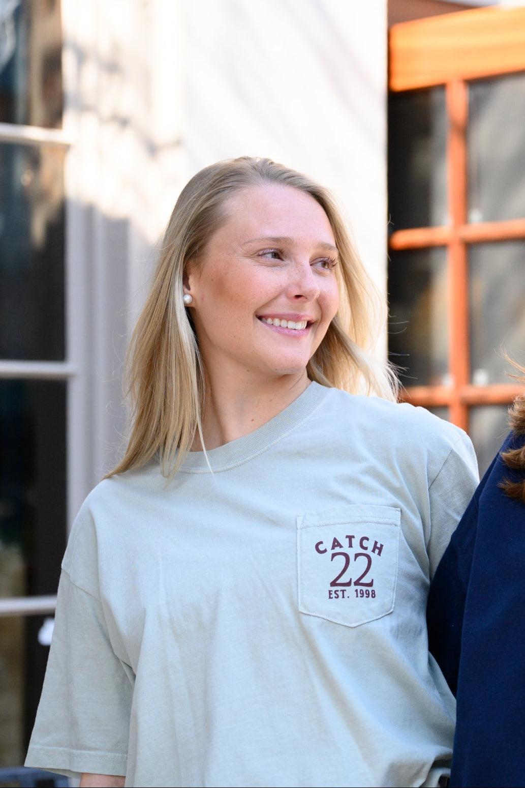 Front pocket design with Brown text “Catch 22- EST. 1998”