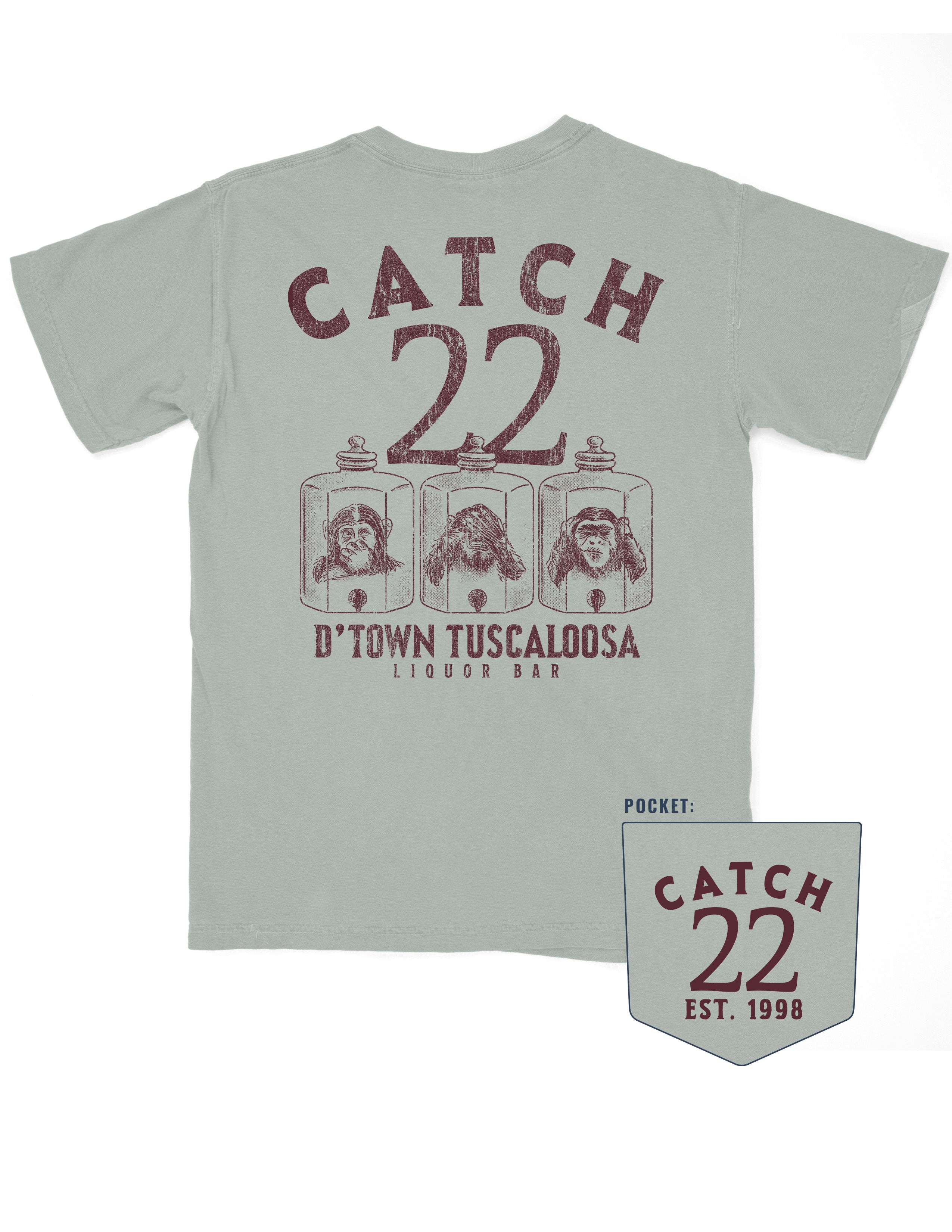 Catch 22 Dusty Green T-Shirt with Brown text “Catch 22” above an illustration of three monkeys in jars playing peekaboo above text “D’Town Tuscaloosa” 