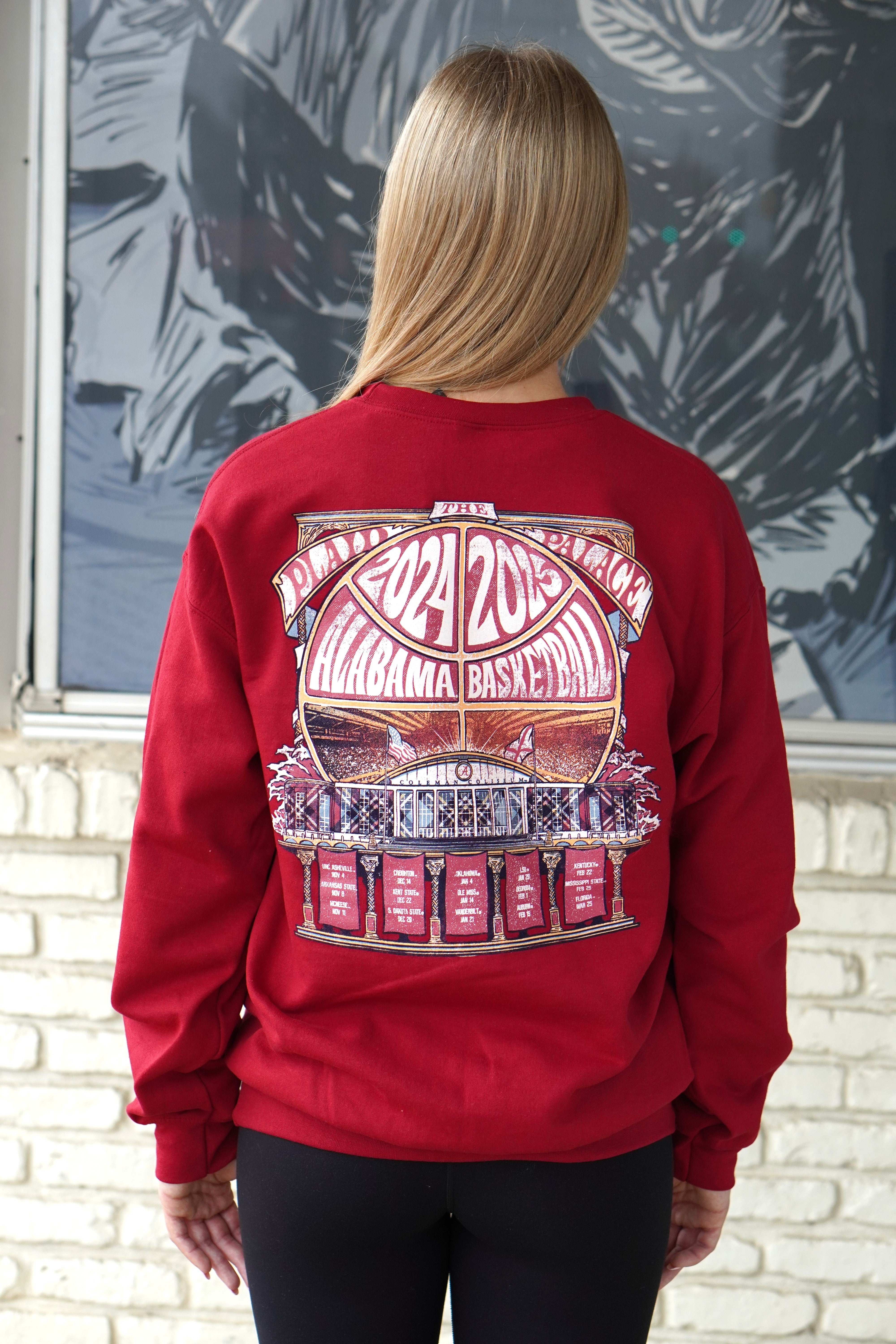 University of Alabama Red Coleman Coliseum Sweatshirt with a graphic of a basketball outline with white text "2024 2025 Alabama Basketball" behind Coleman Coliseum