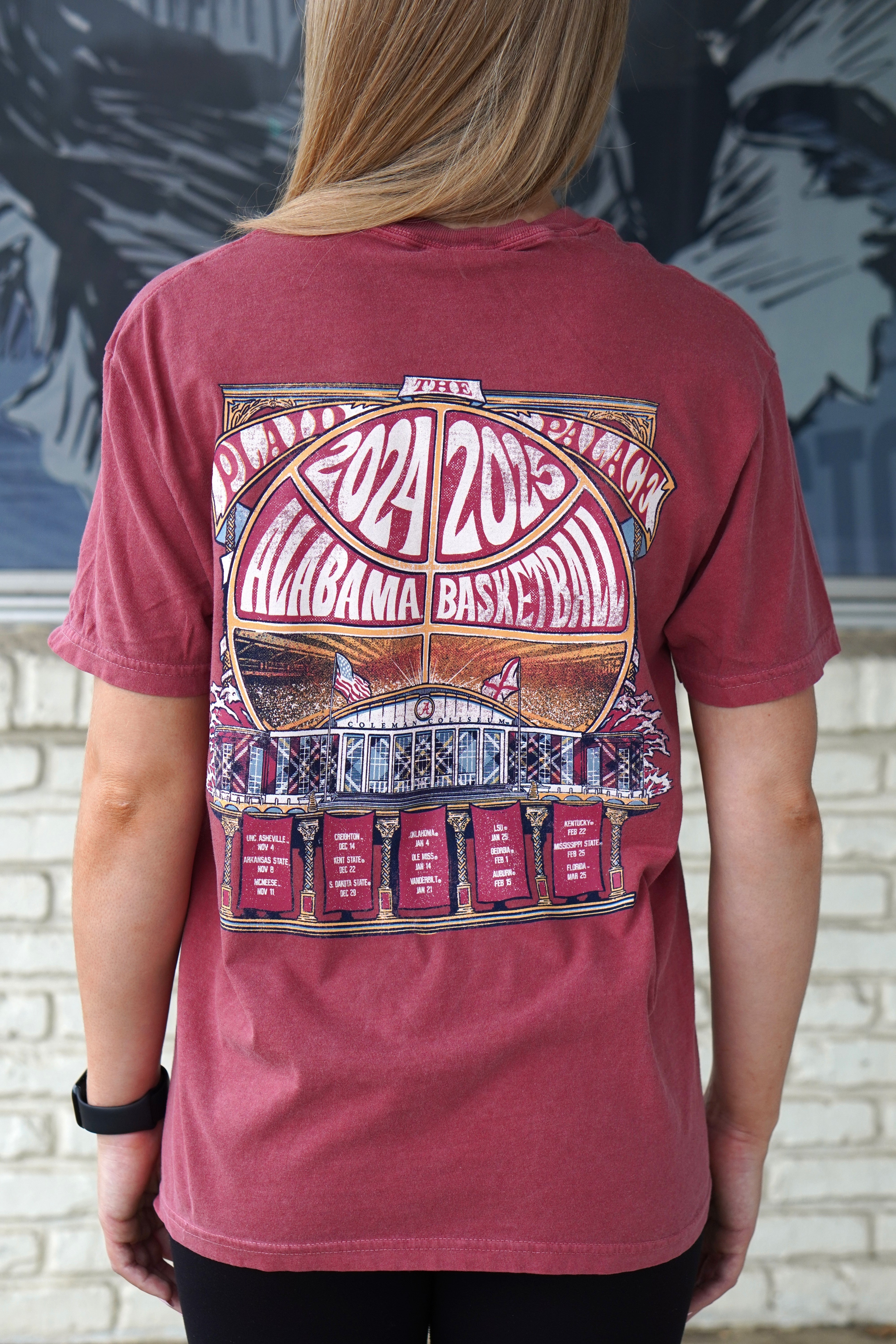 University of Alabama Red Coleman Coliseum T-Shirt with a graphic of a basketball outline with white text "2024 2025 Alabama Basketball" behind Coleman Coliseum