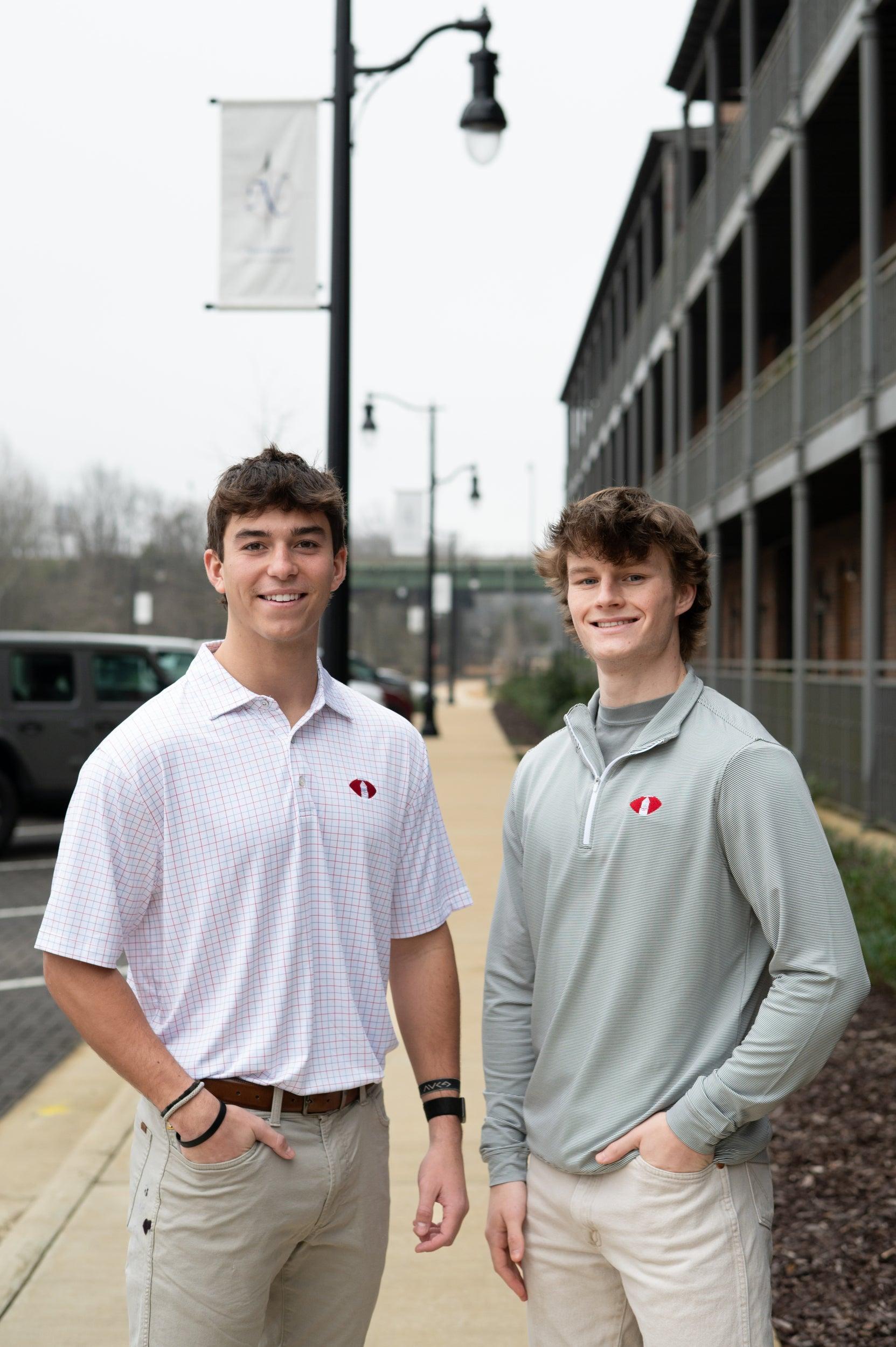 Two men wearing the Denny Chimes Football polo and performance pullover