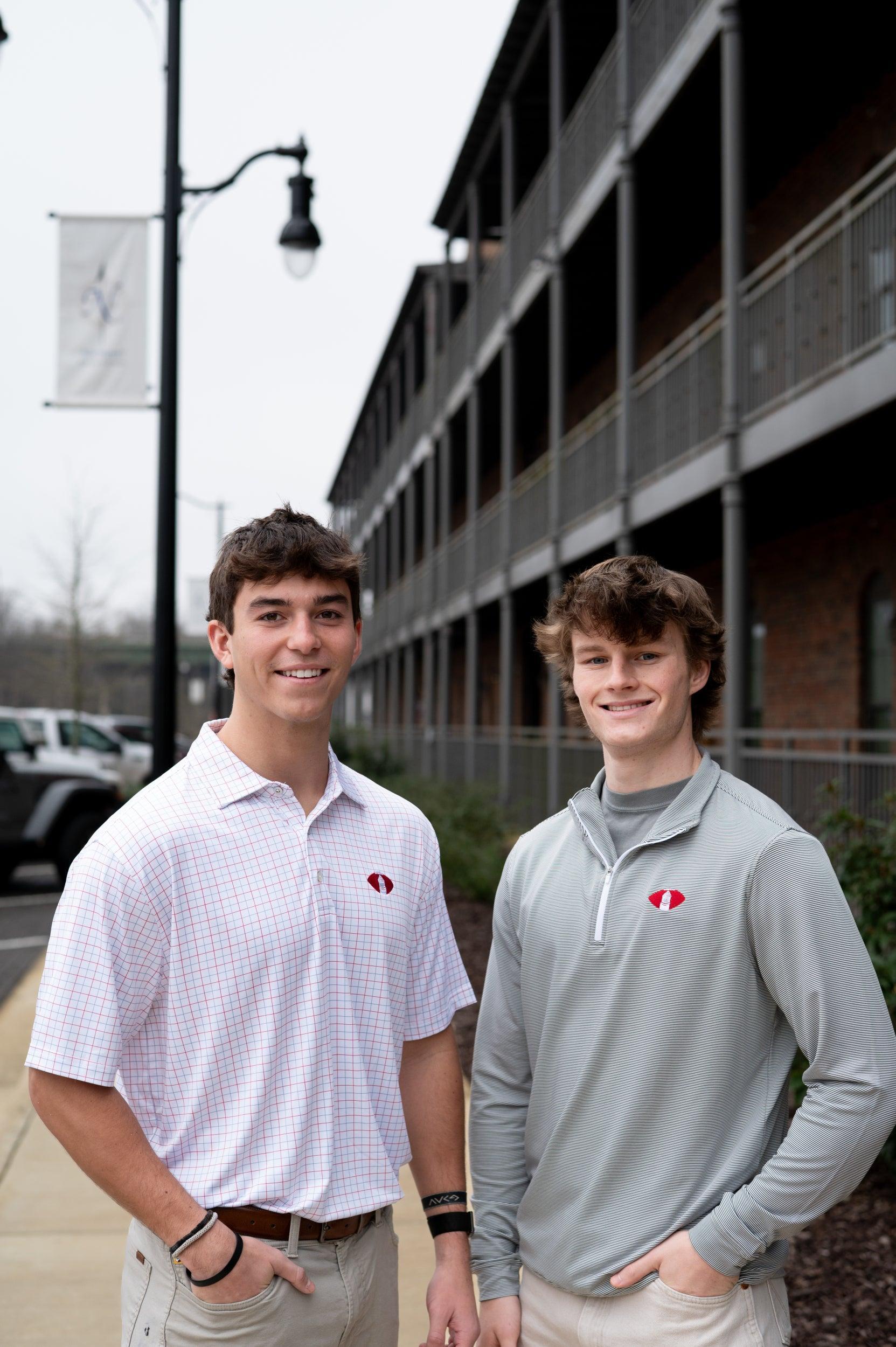Two men wearing the Denny Chimes Football polo and performance pullover
