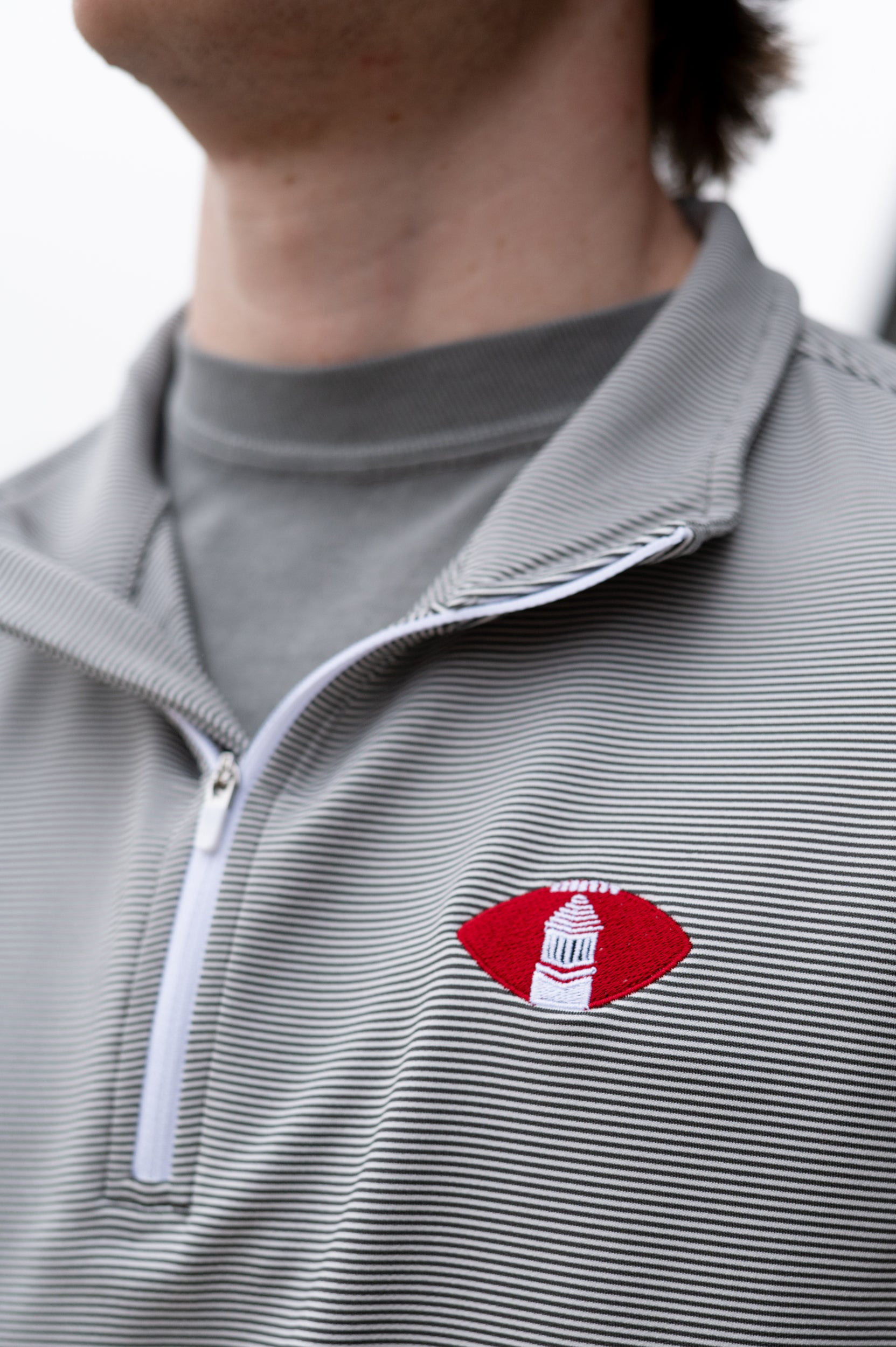 University of Alabama Grey Striped Men’s ¼ Zip Pullover with Denney Chimes in a football embroidered on the chest 