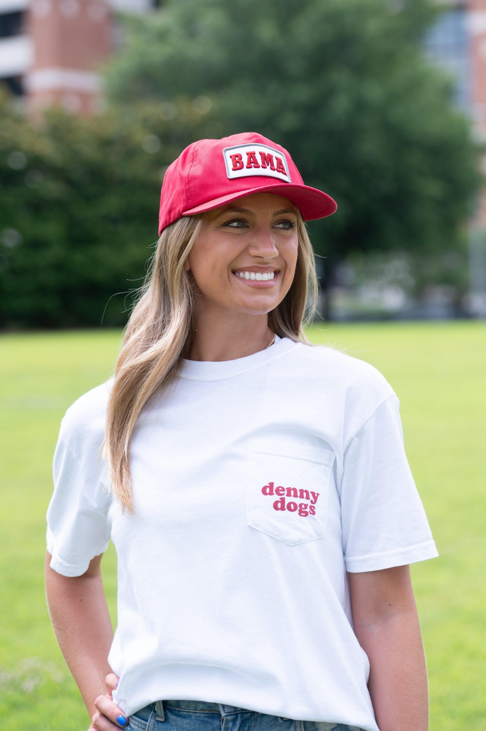 University of Alabama White Denny Dogs Comfort Colors T-Shirt with an image of two hands holding hot dogs at Bryant- Denny Stadium above the Black text "denny dogs"