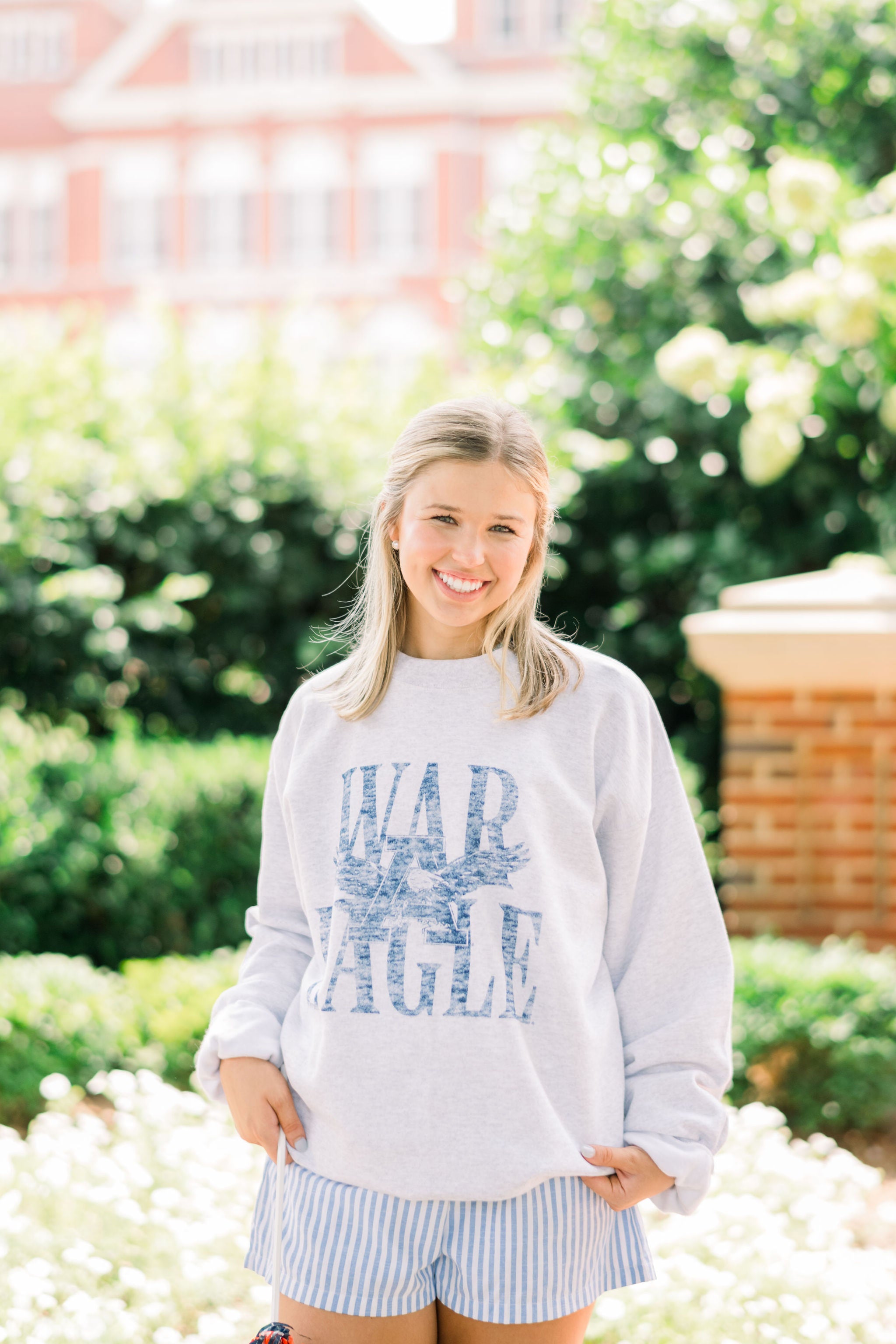 Auburn University Light Grey Sweatshirt with Distressed Blue text “WAR EAGLE” behind the Auburn Eagle logo