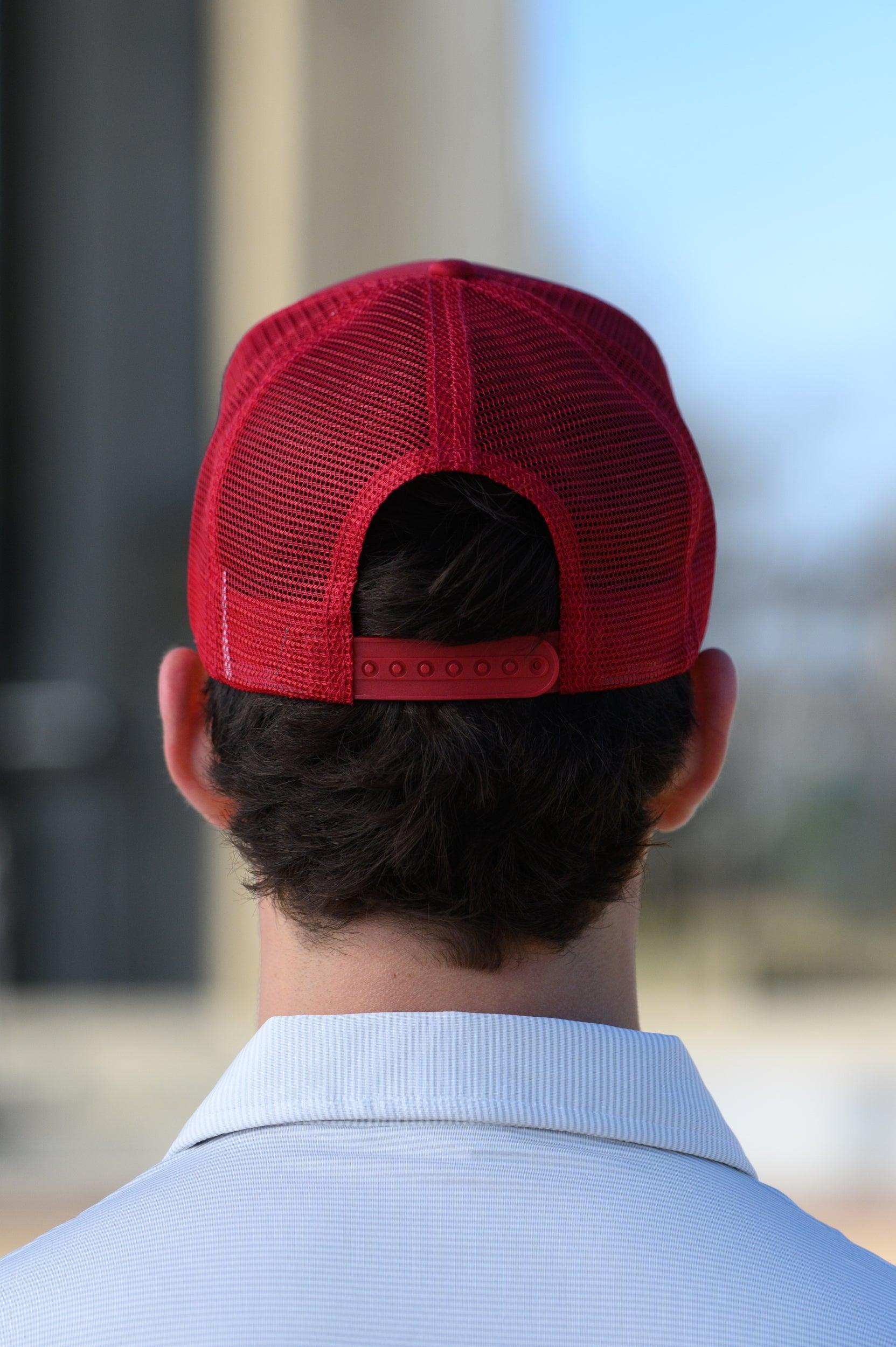 University of Alabama Red Trucker Hat with a patch featuring text “Dixieland” above and “Delight” below drawings of a cowboy boot, money, drink can, football, and playing card
snapback trucker