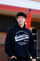 Gallettes Black Hoodie with a White Gallettes logo surrounded by White text "Home of the Yellow Hammer!" and "On the Strip- A Gameday Tradition"