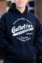 Gallettes Black Hoodie with a White Gallettes logo surrounded by White text "Home of the Yellow Hammer!" and "On the Strip- A Gameday Tradition"