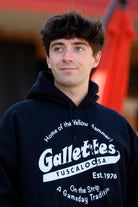 Gallettes Black Hoodie with a White Gallettes logo surrounded by White text "Home of the Yellow Hammer!" and "On the Strip- A Gameday Tradition"