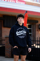 Gallettes Black Hoodie with a White Gallettes logo surrounded by White text "Home of the Yellow Hammer!" and "On the Strip- A Gameday Tradition"