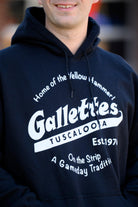 Gallettes Black Hoodie with a White Gallettes logo surrounded by White text "Home of the Yellow Hammer!" and "On the Strip- A Gameday Tradition"