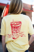Gallettes Yellow T-Shirt with a Red illustration of a full Gallettes cup behind a banner with text "Home of the Yellow Hammer"