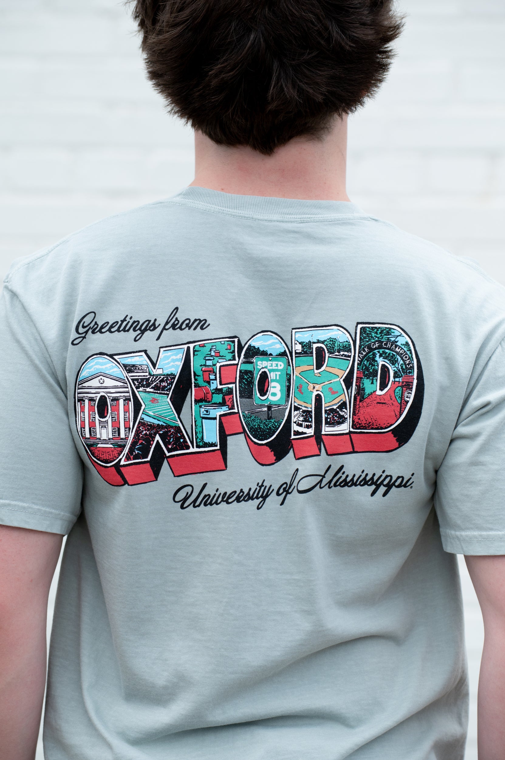 Ole Miss Green T-Shirt with postcard style text "Greetings From OXFORD" with "Oxford" filled with images of iconic buildings in that location