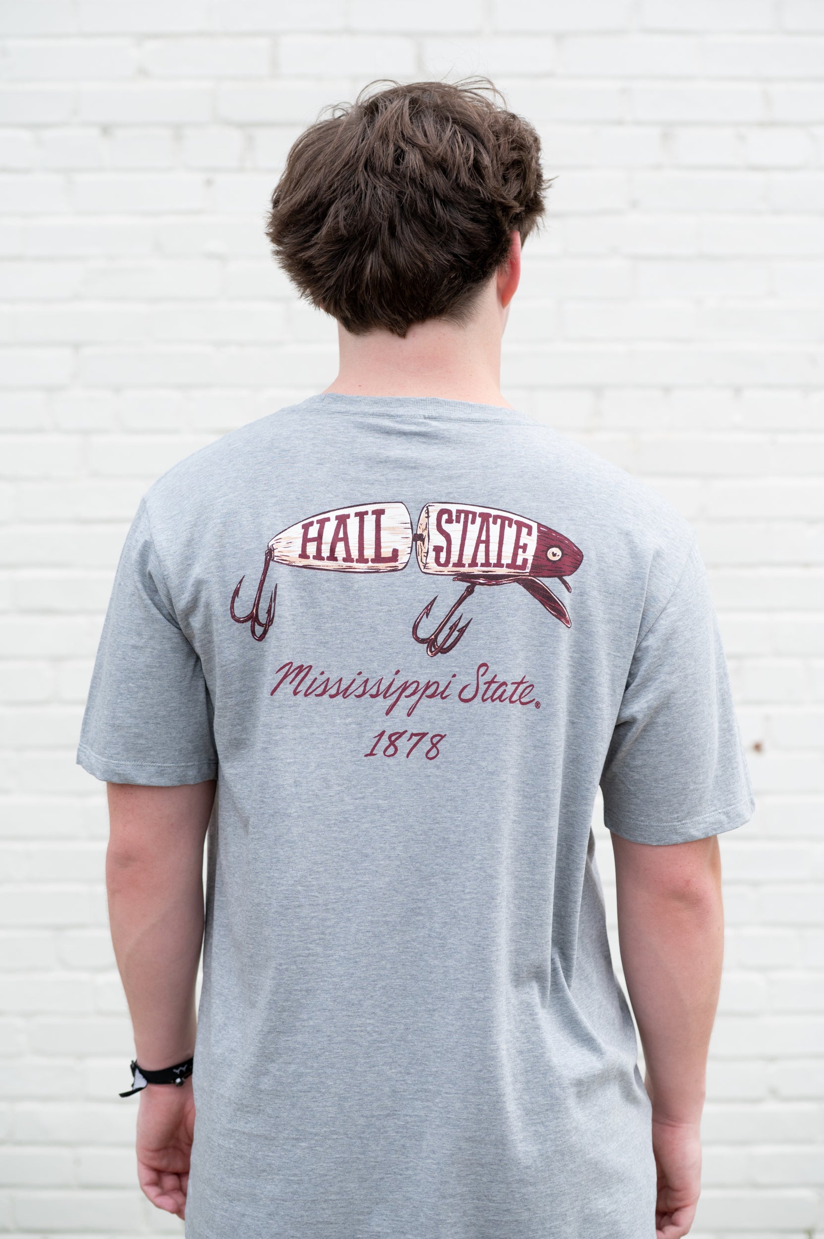 Mississippi State Grey T-Shirt with an image of a fishing lure with Red text “Hail State”