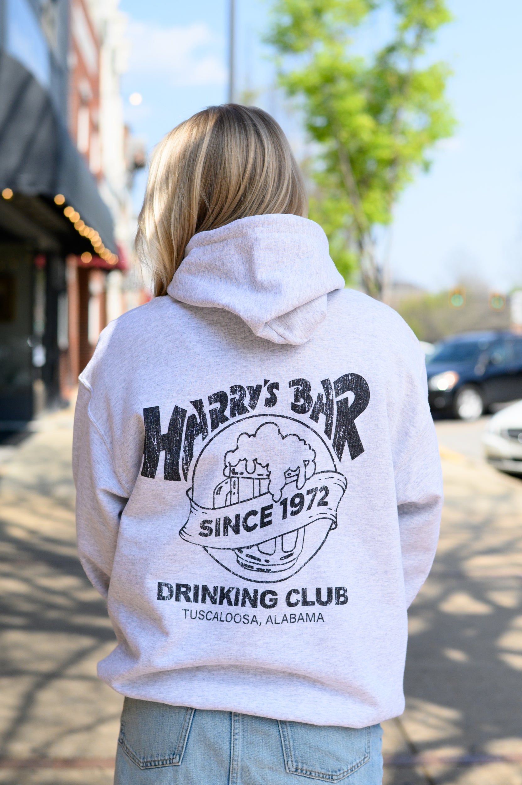 Harry’s Bar Grey Hoodie with an image of an overflowing beer mug with a sash reading “Since 1972” above the text “Drinking Club”