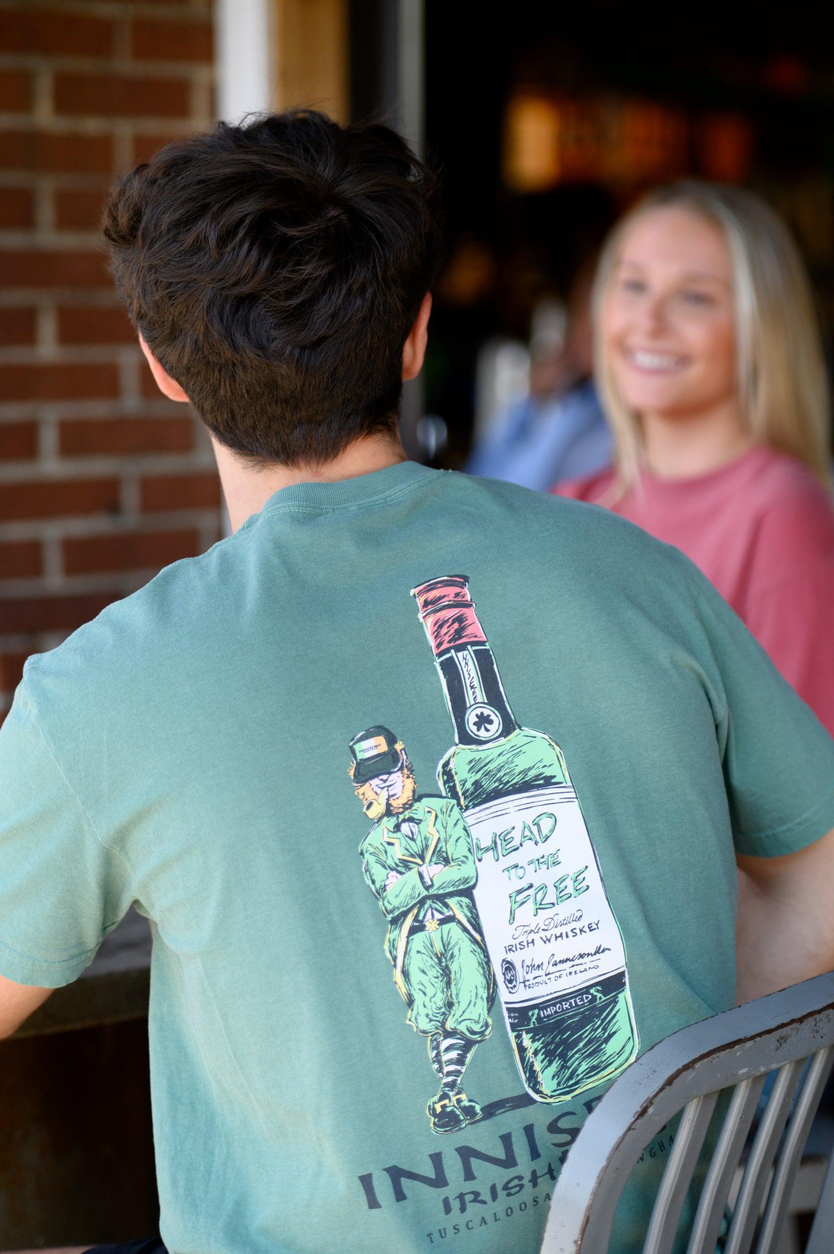 Innisfree Green T-Shirt with a hand-drawn design featuring a leprechaun leaning against a bottle and the text 'INNISFREE Irish Pub' on the back.
