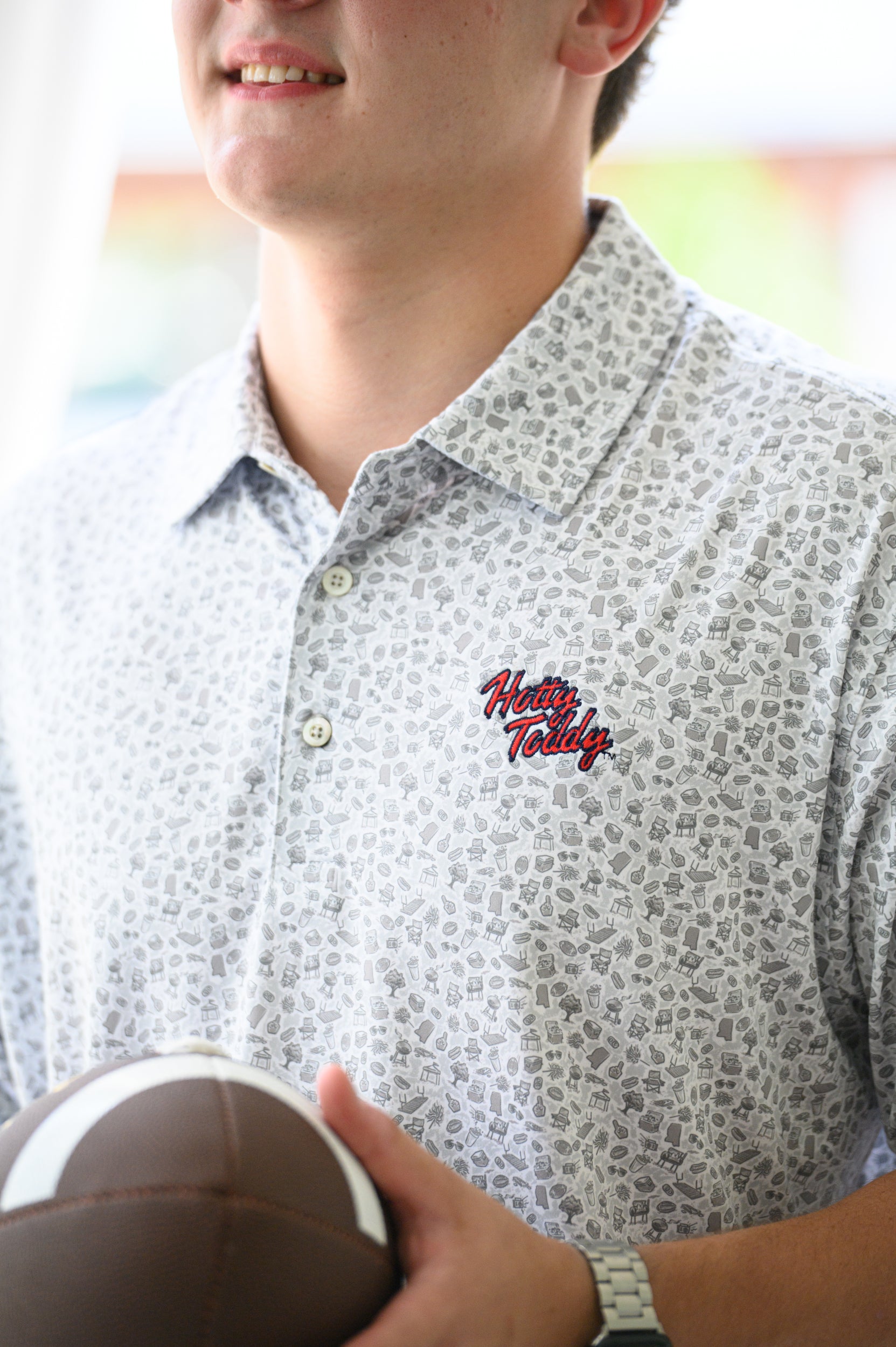 Ole Miss Grey Men’s Patterned Polo with a tailgate themed pattern and Red script “Hotty Toddy” embroidery