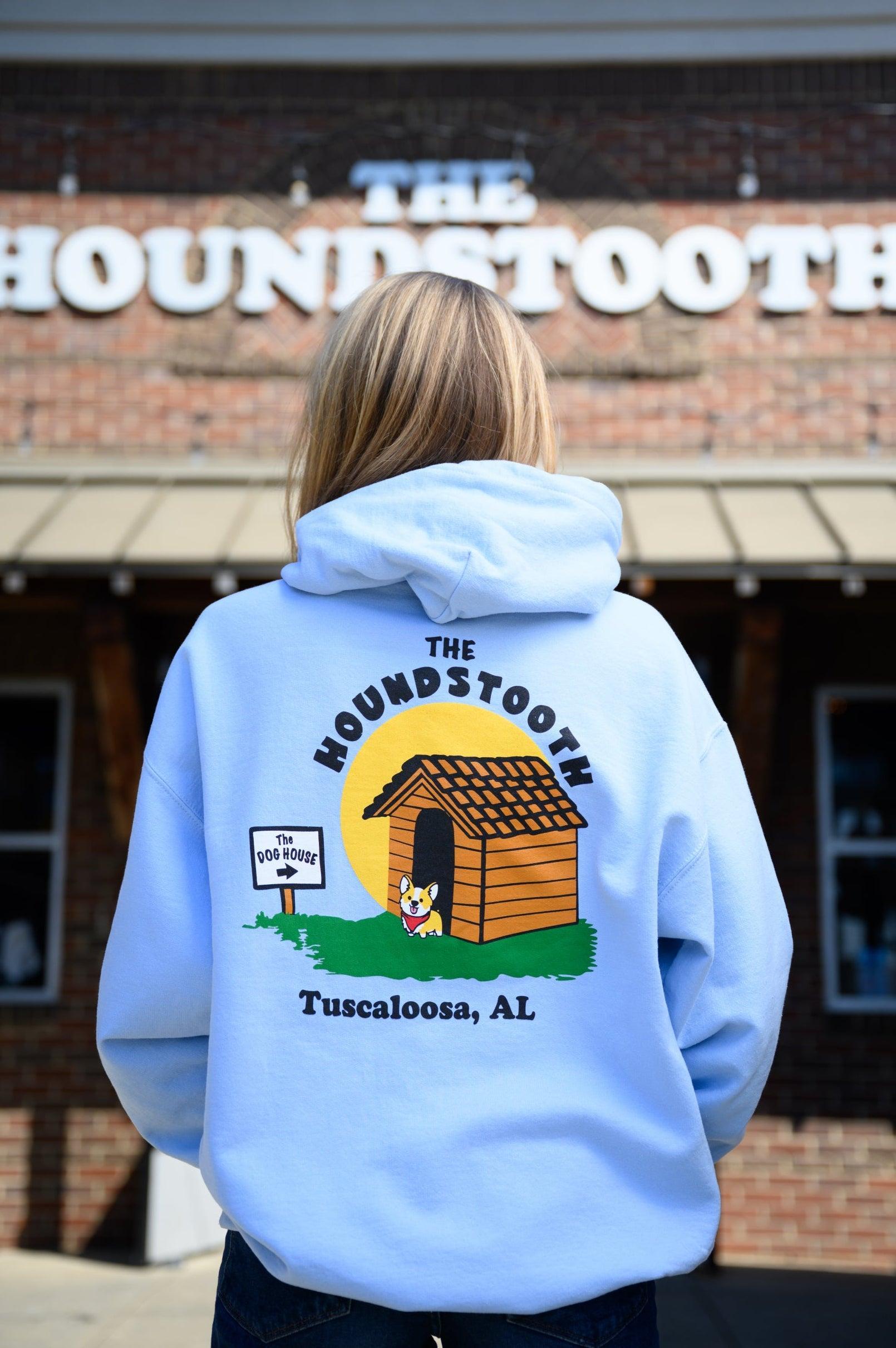 The Houndstooth Light Blue Hoodie with Black text "The Houndstooth" above an image of a corgi standing outside of a doghouse