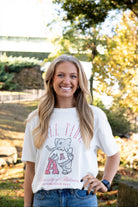 University of Alabama Ivory T-Shirt with Red text “Roll Tide” above an image of Big Al leaning on a Black A