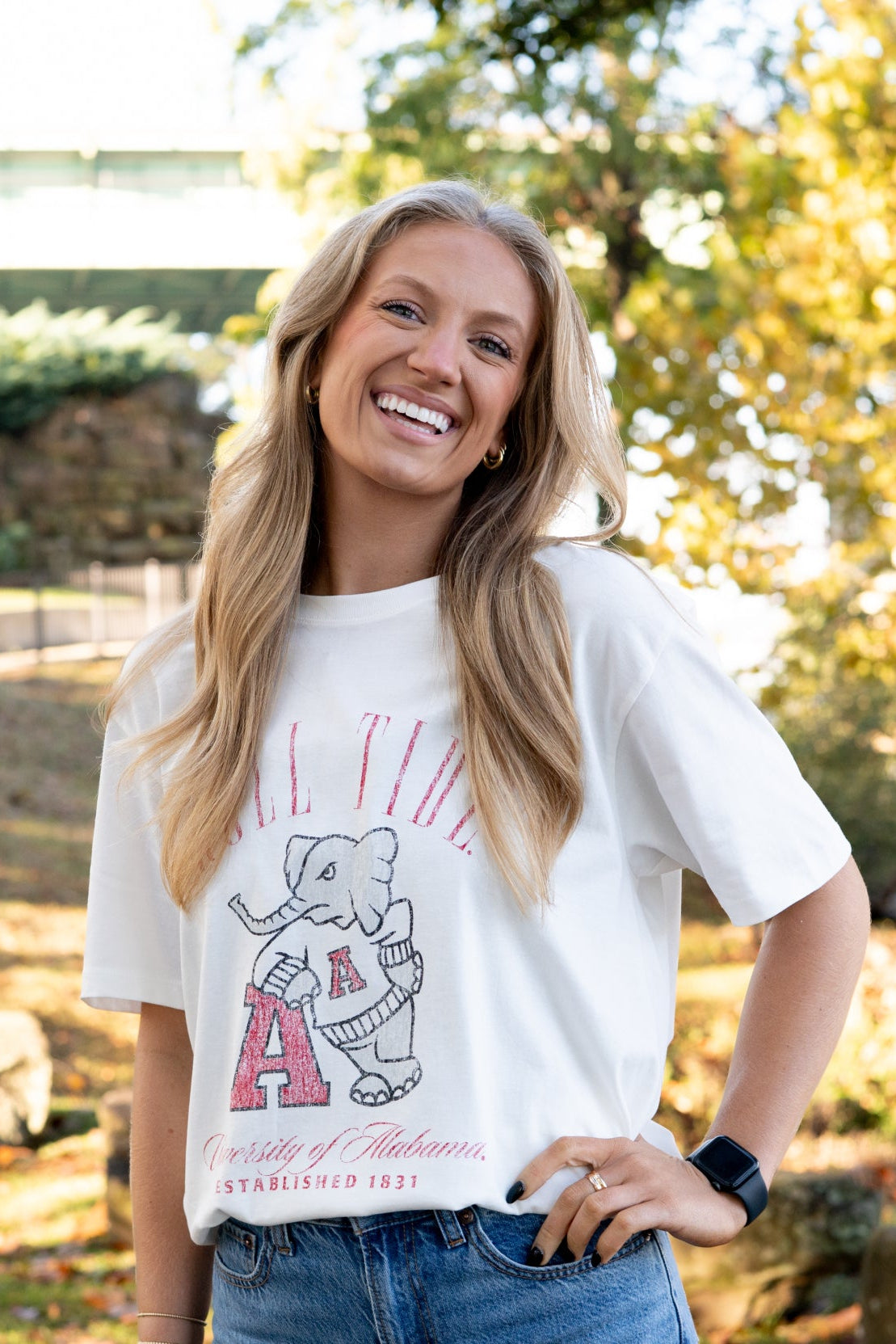 University of Alabama Ivory T-Shirt with Red text “Roll Tide” above an image of Big Al leaning on a Black A