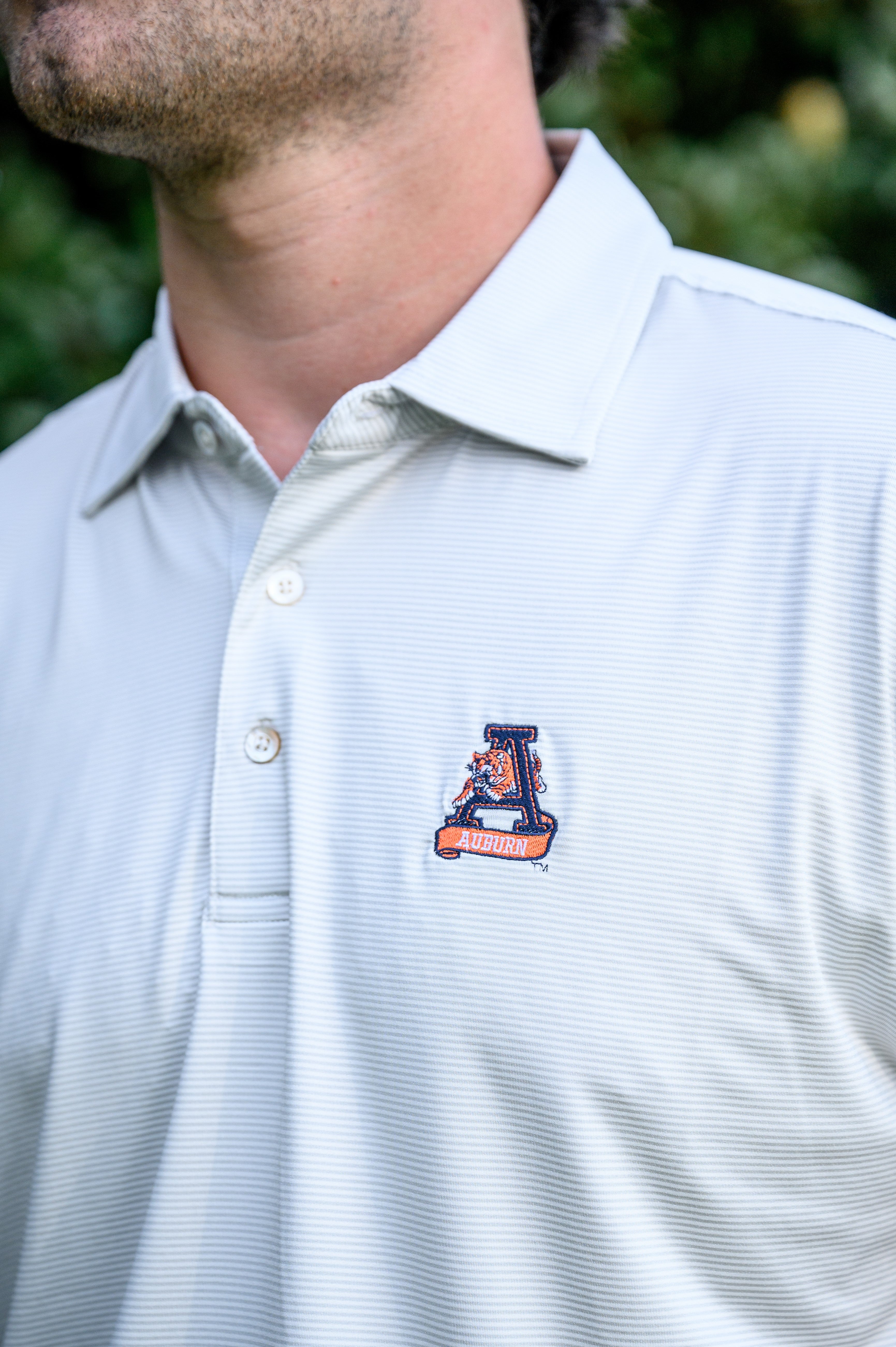 Auburn University Light Grey Men’s Polo with embroidery of Aubie leaping through an "A"