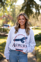 Auburn University Grey Sweatshirt with an image of an eagle flying under Orange text “Loveliest Village of the Plains” and above text “Auburn University”