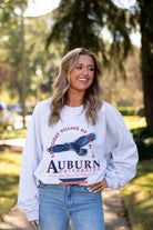 Auburn University Grey Sweatshirt with an image of an eagle flying under Orange text “Loveliest Village of the Plains” and above text “Auburn University”