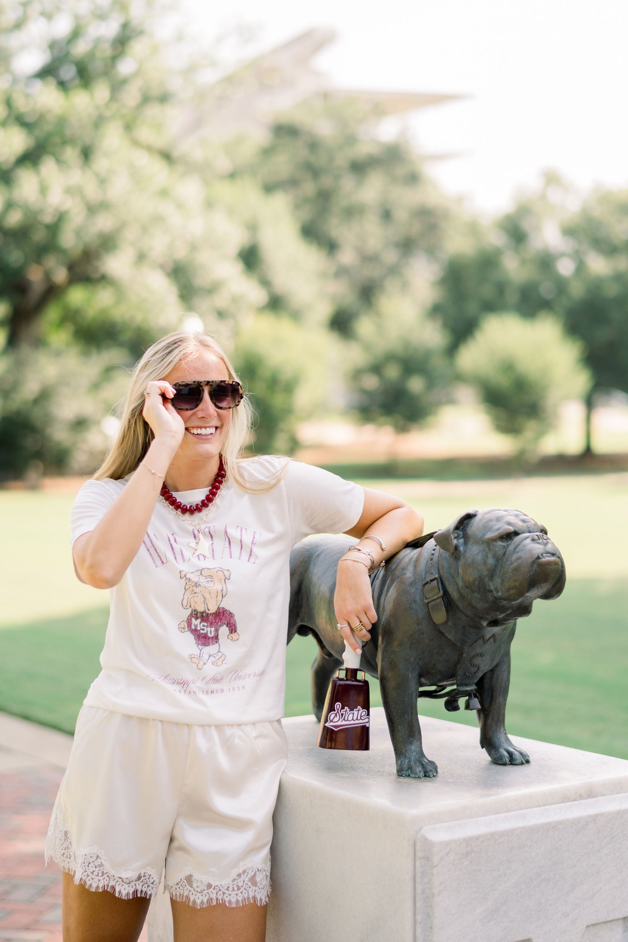 Mississippi State Ivory T-Shirt with Red text “Hail State” above an image of the Walking Bully Logo