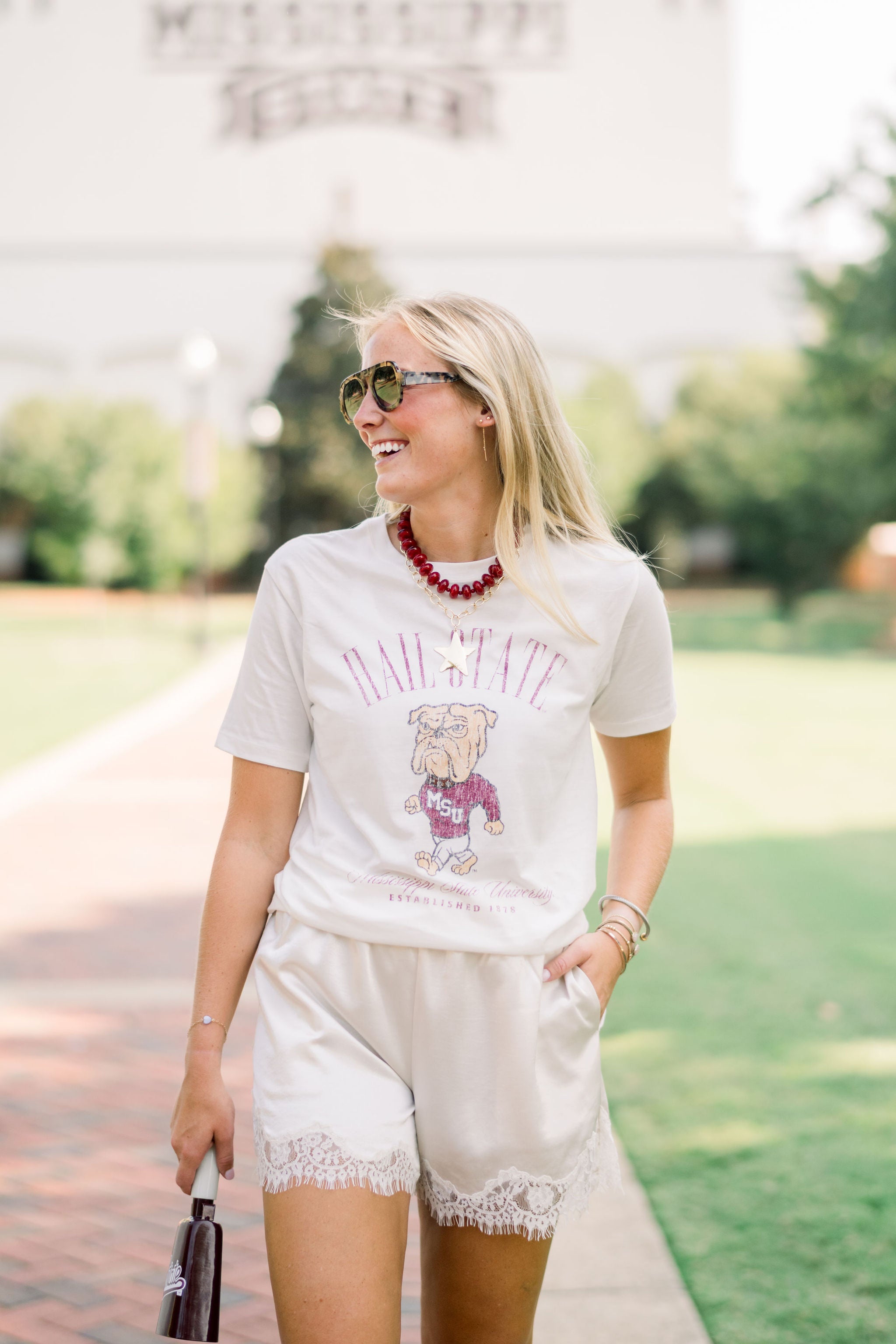 Mississippi State Ivory T-Shirt with Red text “Hail State” above an image of the Walking Bully Logo