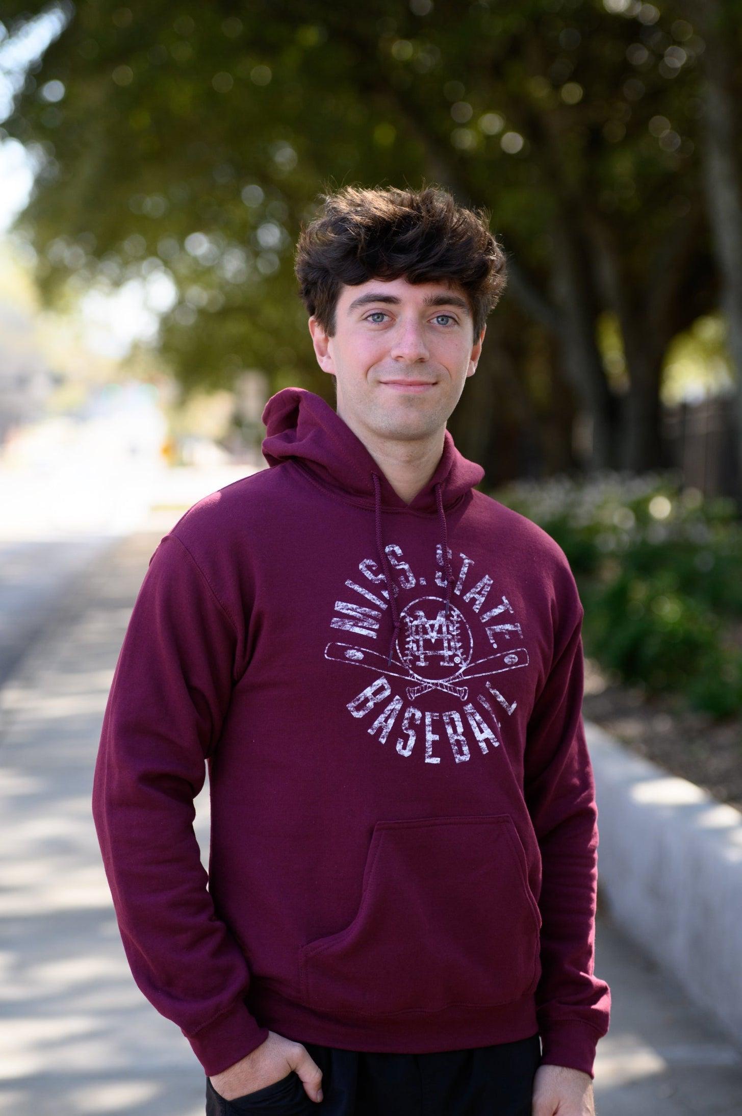 Mississippi State Distressed Dark Red Hoodie with a White Baseball featuring the MS overlapping logo over crossed baseball bats, surrounded by White text “Miss. State Baseball”