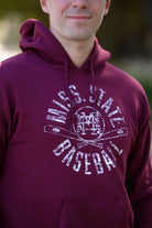 Mississippi State Distressed Dark Red Hoodie with a White Baseball featuring the MS overlapping logo over crossed baseball bats, surrounded by White text “Miss. State Baseball”